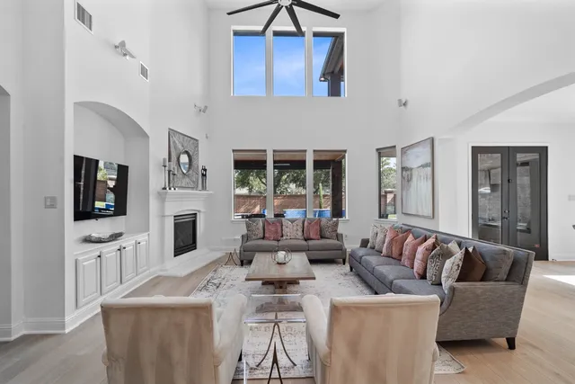 a kitchen with stainless steel appliances granite countertop a kitchen island a stove and a wooden floor