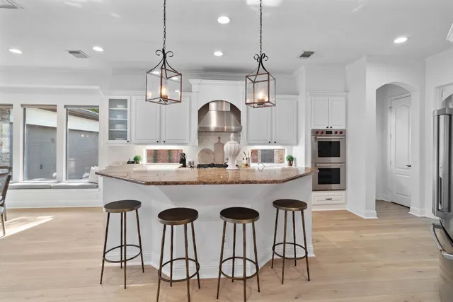 a kitchen with stainless steel appliances granite countertop a stove and a sink