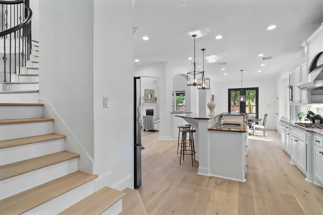 a kitchen with stainless steel appliances granite countertop a sink stove and refrigerator