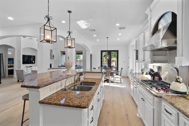 a kitchen with stainless steel appliances granite countertop a sink and refrigerator