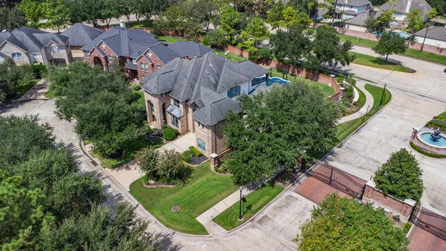 an aerial view of a house with garden space and street view