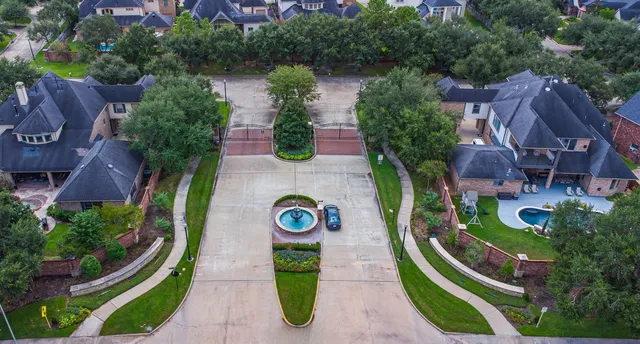 an aerial view of a house with outdoor space and lake view in back