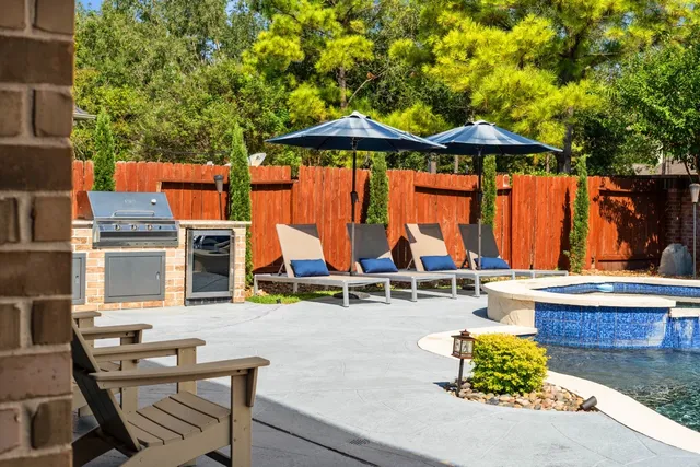 a view of swimming pool with outdoor seating and plants