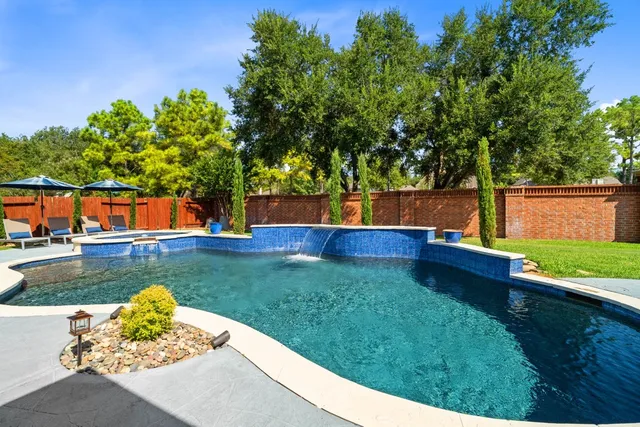 a view of a patio with chairs and a potted plant