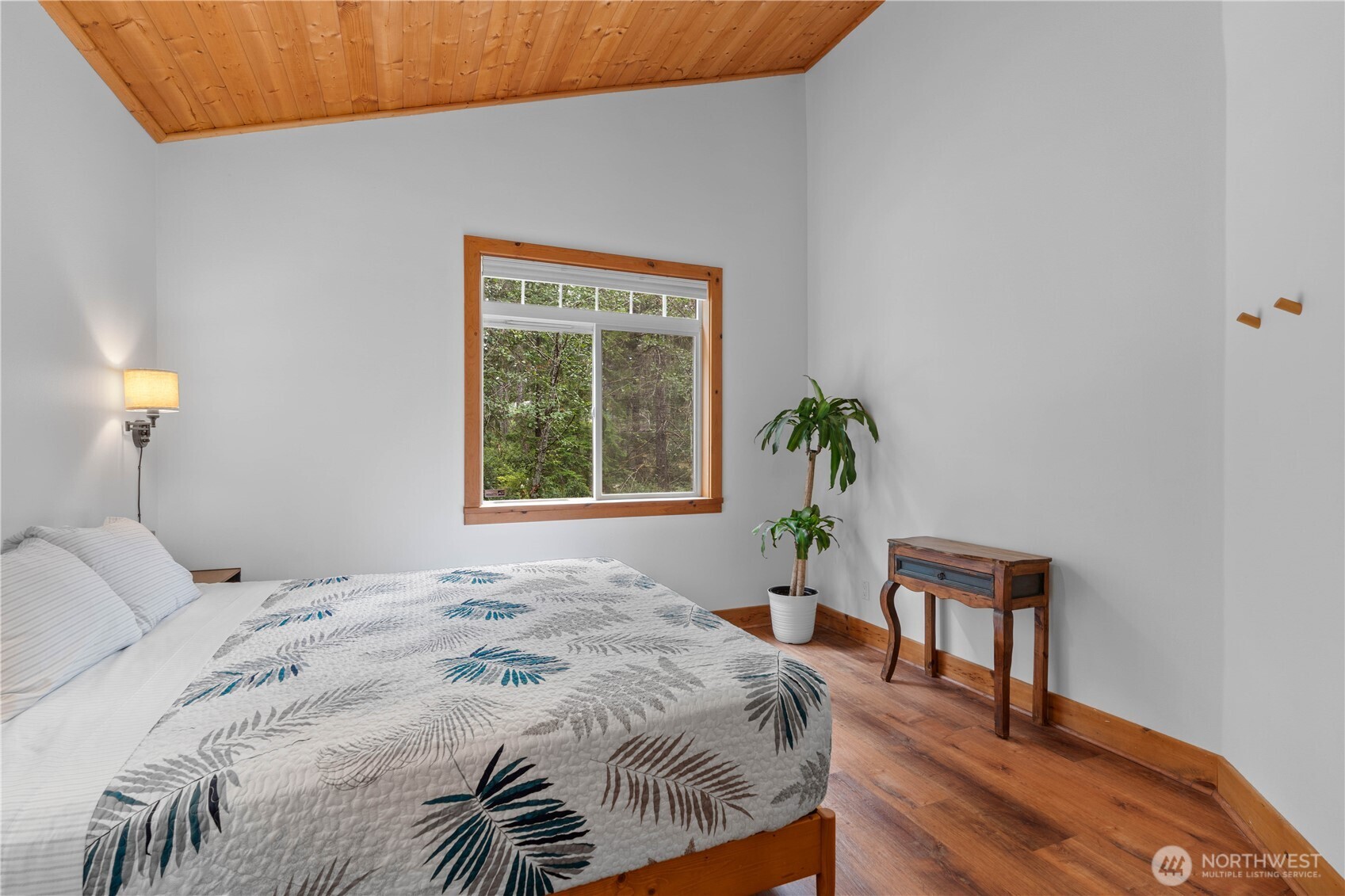 7131 Northeast Tahuya Blacksmith Road Belfair, WA 98528 - Photo 11 of 33 a bedroom with a bed and a window