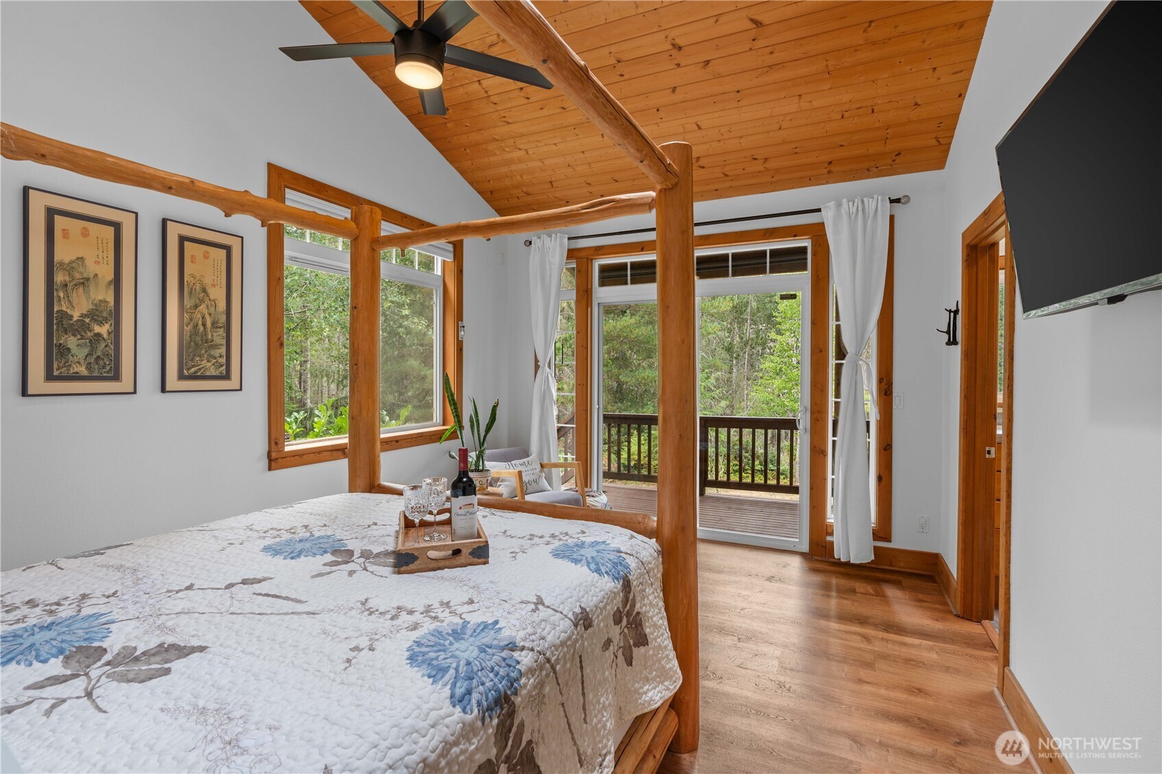 7131 Northeast Tahuya Blacksmith Road Belfair, WA 98528 - Photo 13 of 33 a bed sitting in a spacious bedroom next to a window