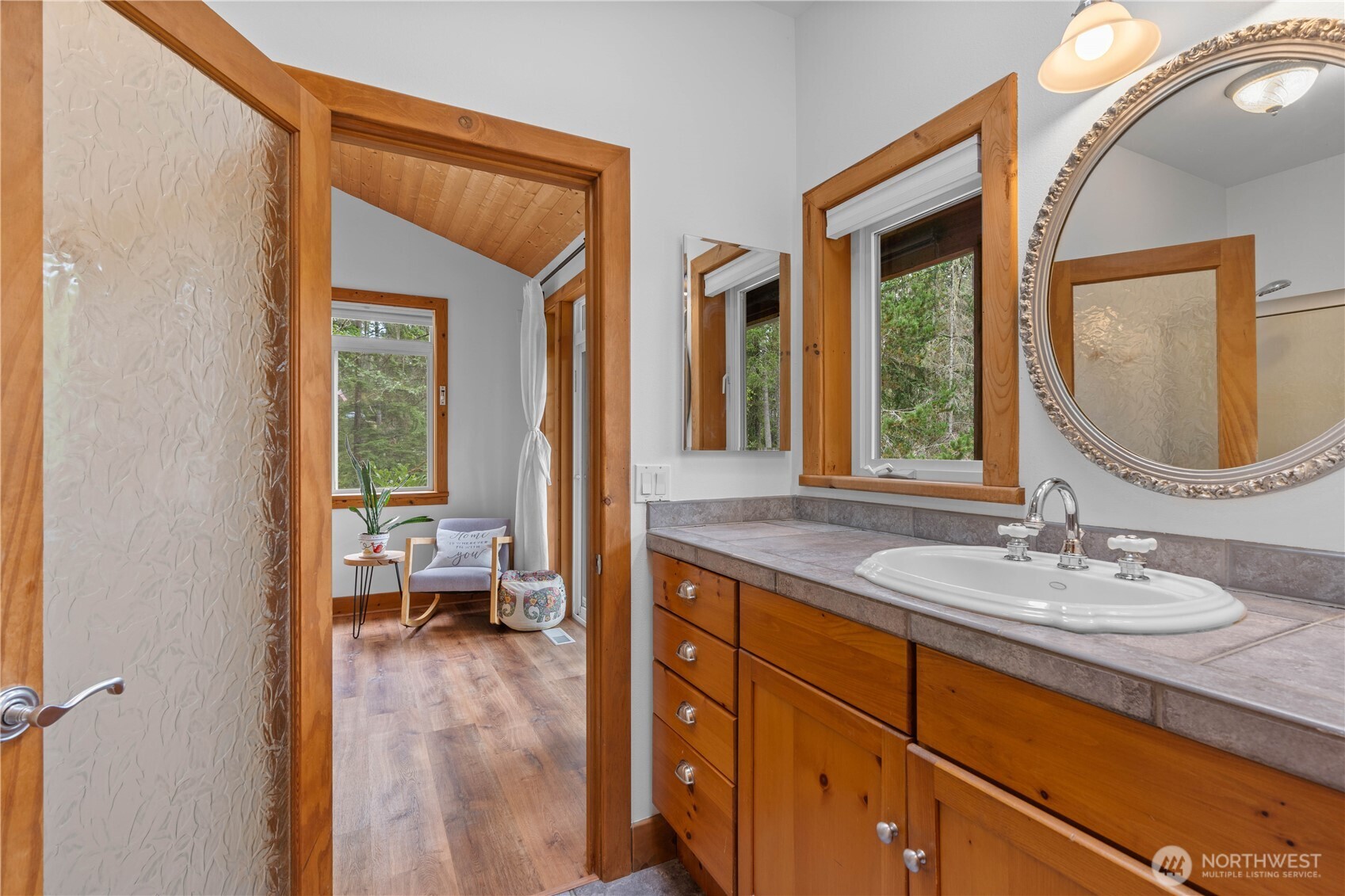 7131 Northeast Tahuya Blacksmith Road Belfair, WA 98528 - Photo 15 of 33 a en suite bathroom with a granite countertop sink and a mirror