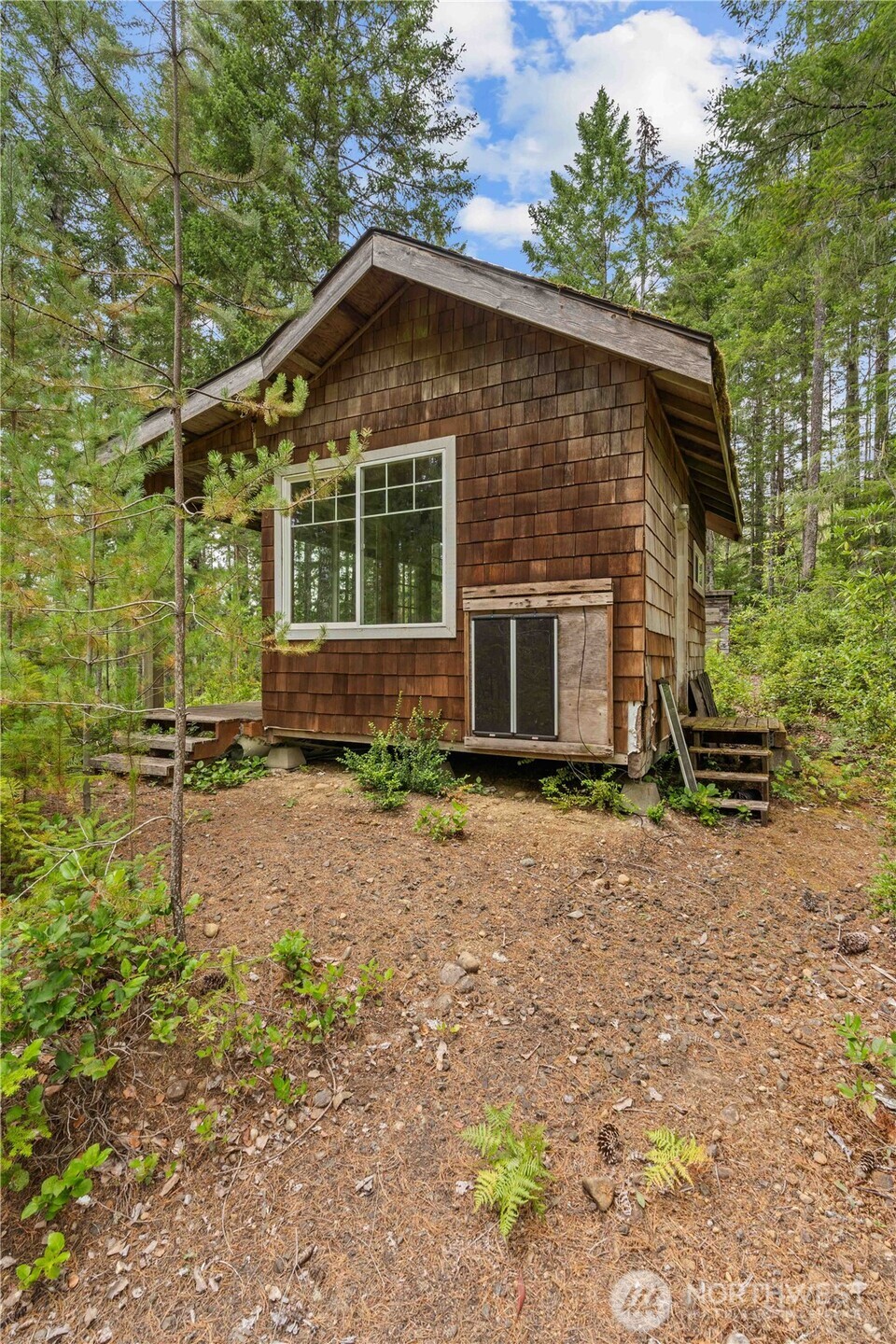 7131 Northeast Tahuya Blacksmith Road Belfair, WA 98528 - Photo 25 of 33 a front view of a house with garden
