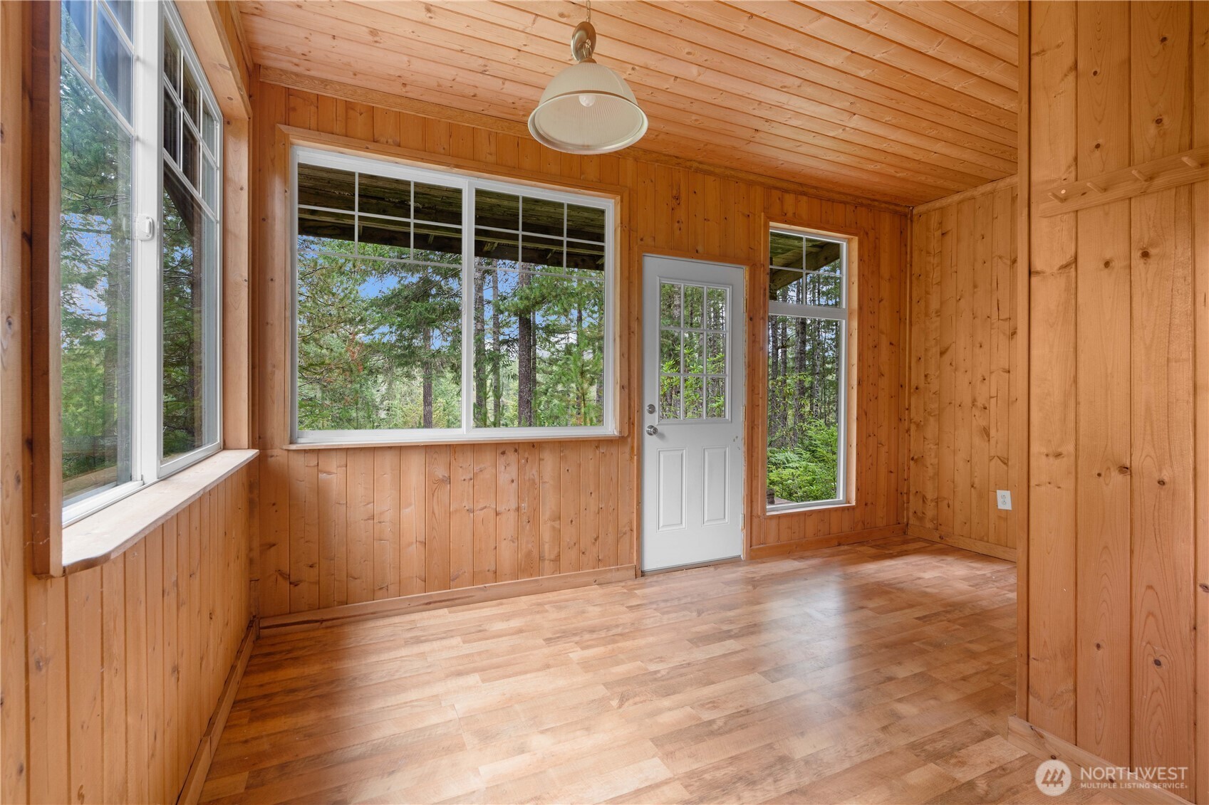7131 Northeast Tahuya Blacksmith Road Belfair, WA 98528 - Photo 26 of 33 a view of an empty room with wooden floor and fan
