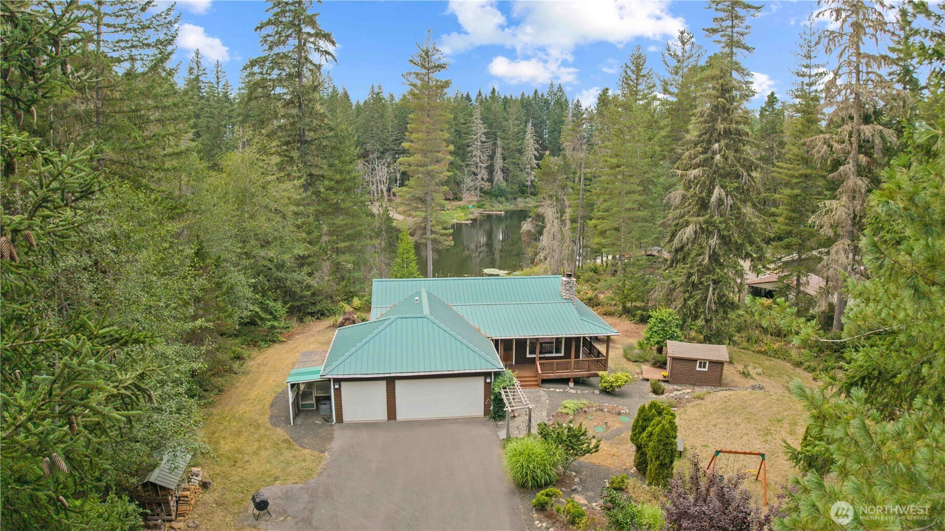 7131 Northeast Tahuya Blacksmith Road Belfair, WA 98528 - Photo 29 of 33 aerial view of a house with yard and mountain view