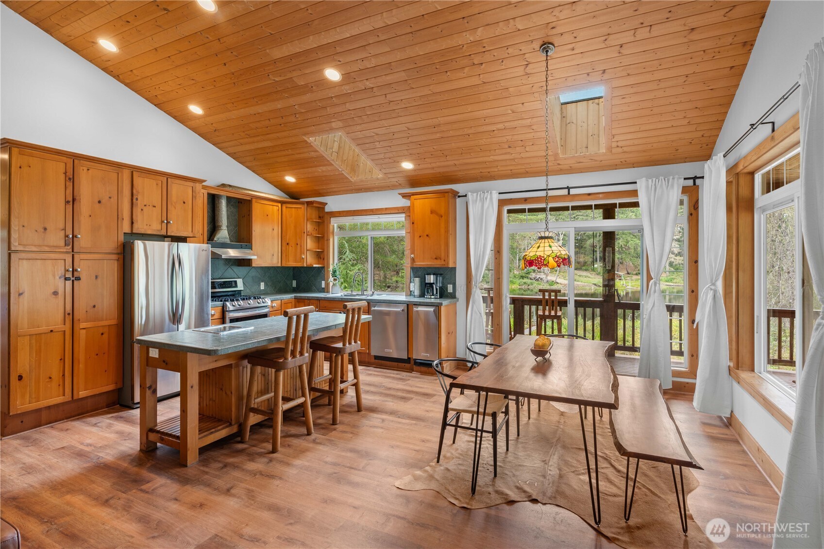 7131 Northeast Tahuya Blacksmith Road Belfair, WA 98528 - Photo 5 of 33 a view of a dining room with furniture window and outside view