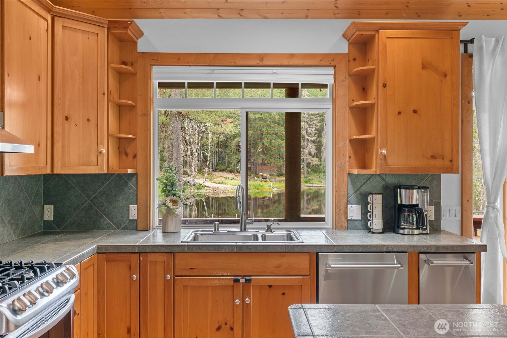 7131 Northeast Tahuya Blacksmith Road Belfair, WA 98528 - Photo 6 of 33 a kitchen with a sink and a large window