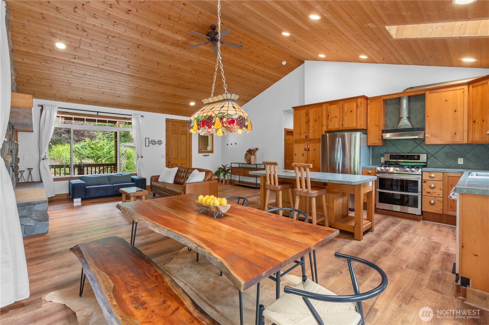 7131 Northeast Tahuya Blacksmith Road Belfair, WA 98528 - Photo 7 of 33 a living room with furniture a large window with kitchen view