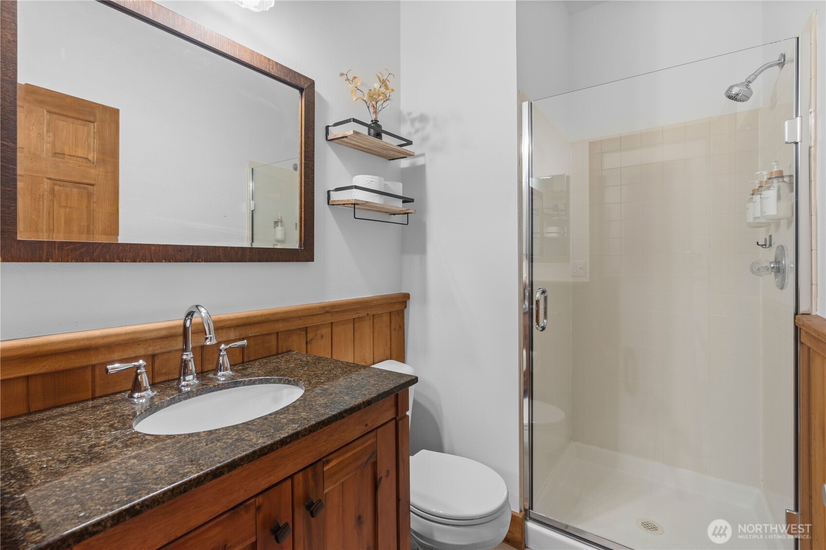 7131 Northeast Tahuya Blacksmith Road Belfair, WA 98528 - Photo 8 of 33 a bathroom with a granite countertop sink toilet a mirror a vanity and shower