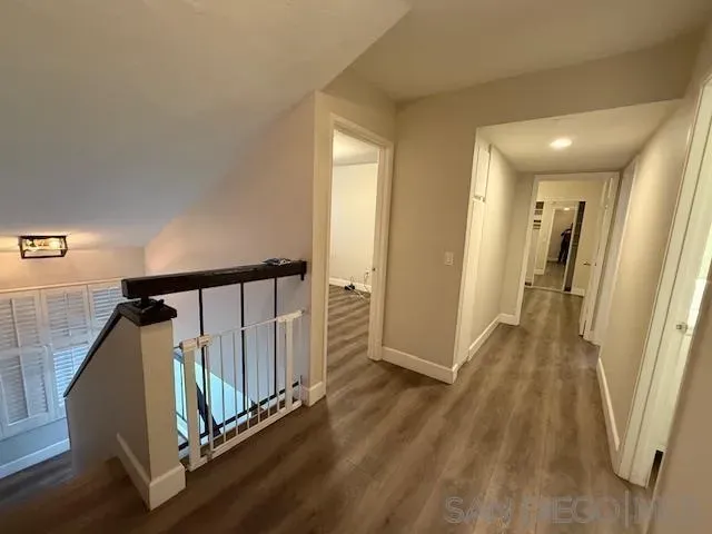 a view of hallway with wooden floor