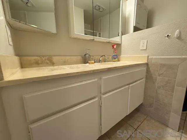 a view of a swimming pool with a patio and a yard