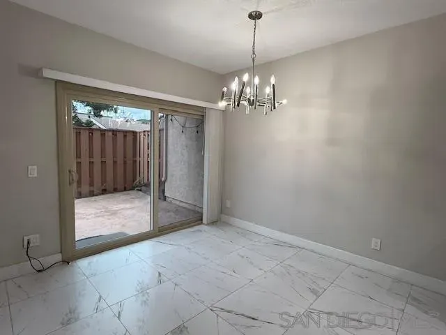 a view of a backyard with wooden fence