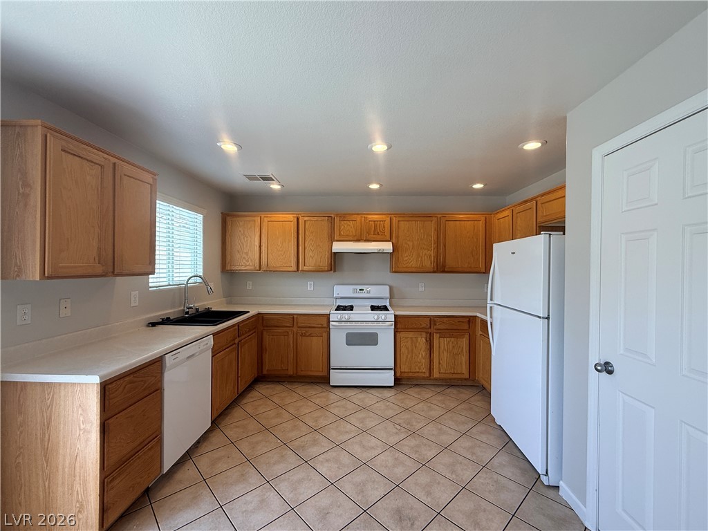 11953 Fairfax Ridge Street Las Vegas, NV 89183 - Photo 5 of 32 A well-appointed kitchen features ample cabinetry and practical tile flooring.