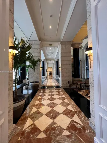 a lobby with furniture and floor to ceiling window