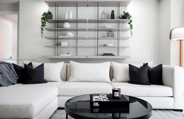 a living room with a couch and a potted plant