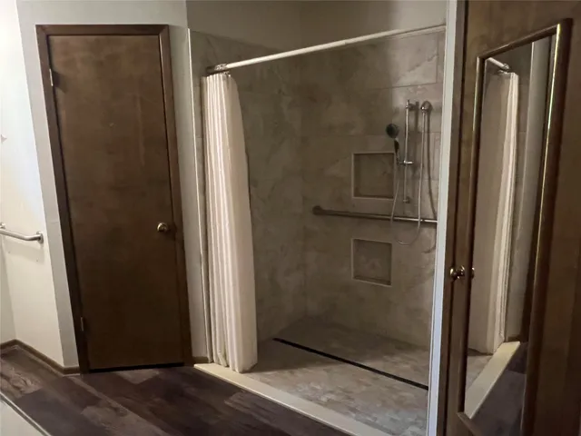 a bathroom with a glass shower door