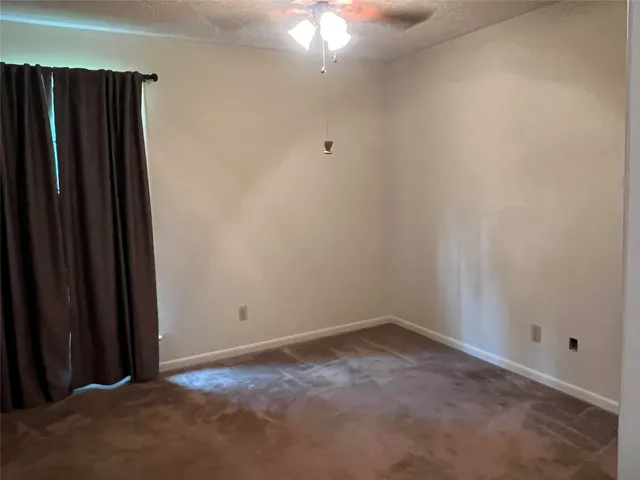 an empty room with windows and yard