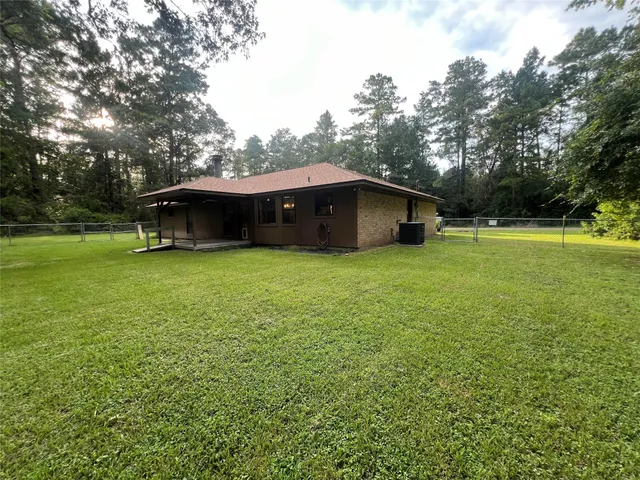 a view of a house with a yard and sitting area