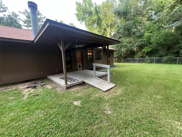 a backyard of a house with table and chairs