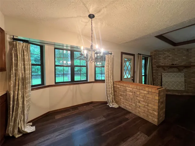 a living room with hardwood floor and a ceiling fan