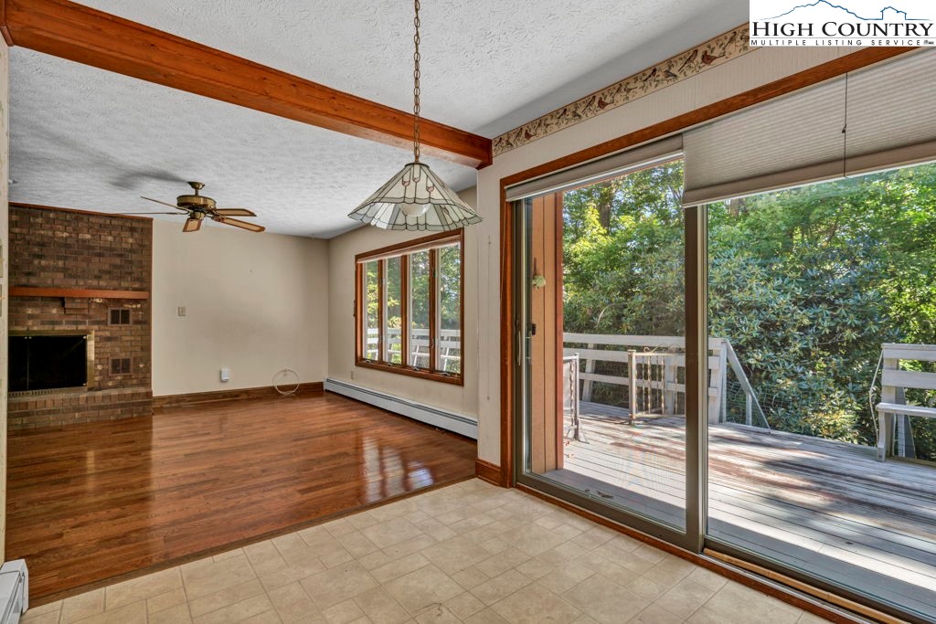 358 Devonwood Drive Boone, NC 28607 - Photo 16 of 50 a view of an empty room with wooden floor and a window