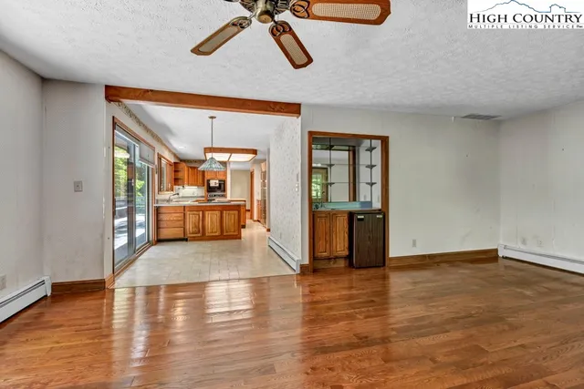 a room with pool table and windows