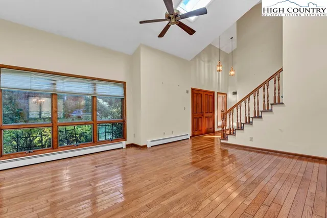 a view of an entryway with wooden floor