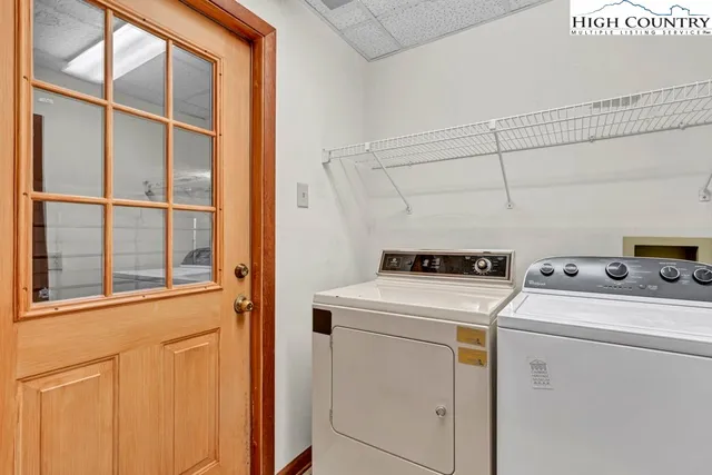a view of a livingroom with a ceiling fan & windows