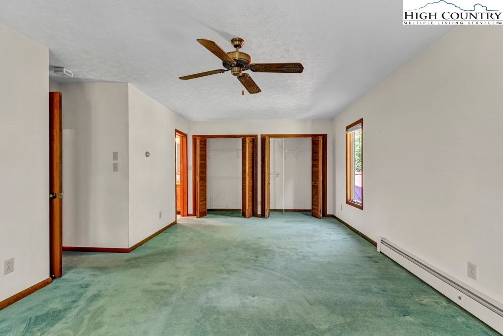 358 Devonwood Drive Boone, NC 28607 - Photo 34 of 50 a view of a livingroom with a ceiling fan & windows