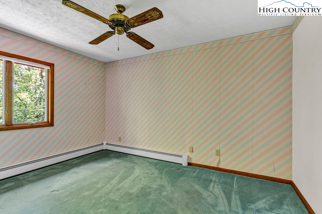 358 Devonwood Drive Boone, NC 28607 - Photo 42 of 50 an empty room with a window and a fan