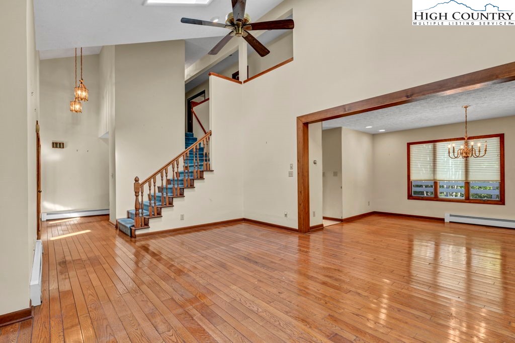 358 Devonwood Drive Boone, NC 28607 - Photo 9 of 50 a view of an empty room with wooden floor and a window