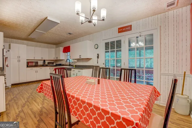 a large kitchen with a table and chairs