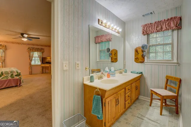 a bathroom with a sink mirror and a bathtub
