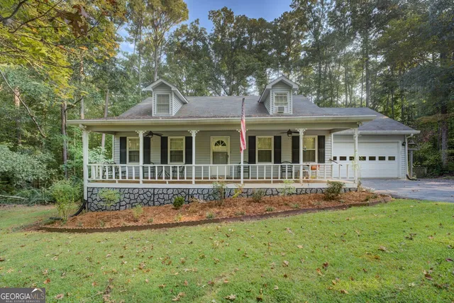 a front view of a house with a yard table and chairs