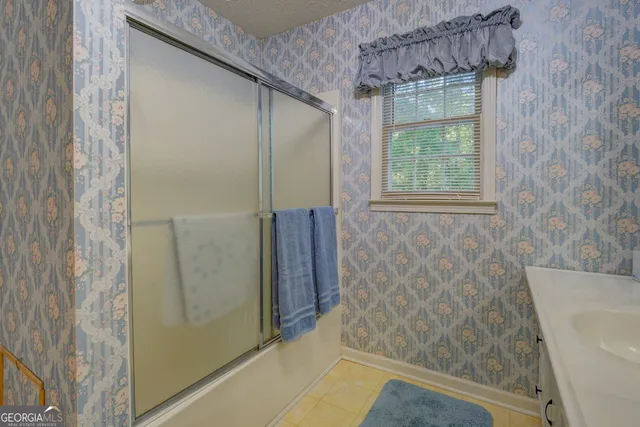 a bathroom with a shower and a tub