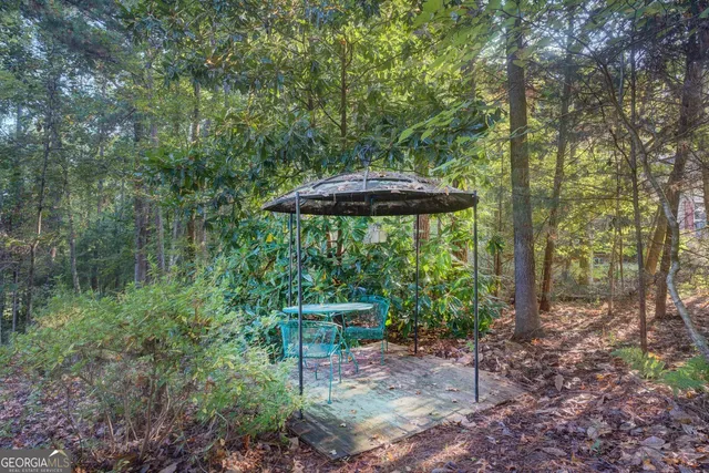 a view of a table and chairs under an umbrella