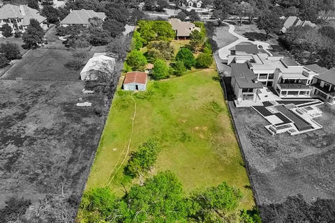 a aerial view of a residential houses with yard