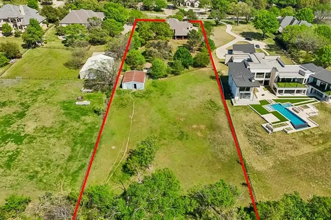 an aerial view of residential houses with outdoor space and swimming pool