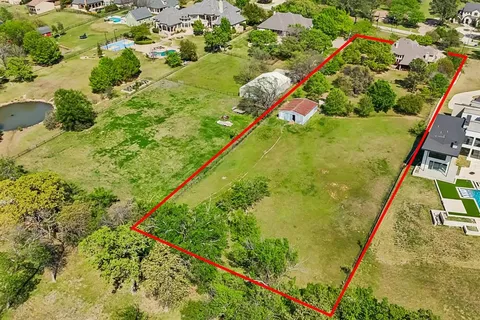 an aerial view of a house with a garden and lake view