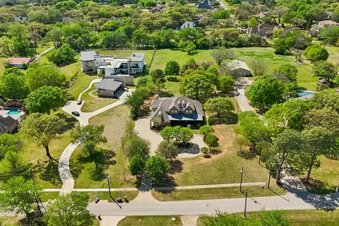 an aerial view of residential houses with outdoor space