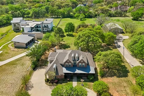 an aerial view of a house with outdoor space and lake view