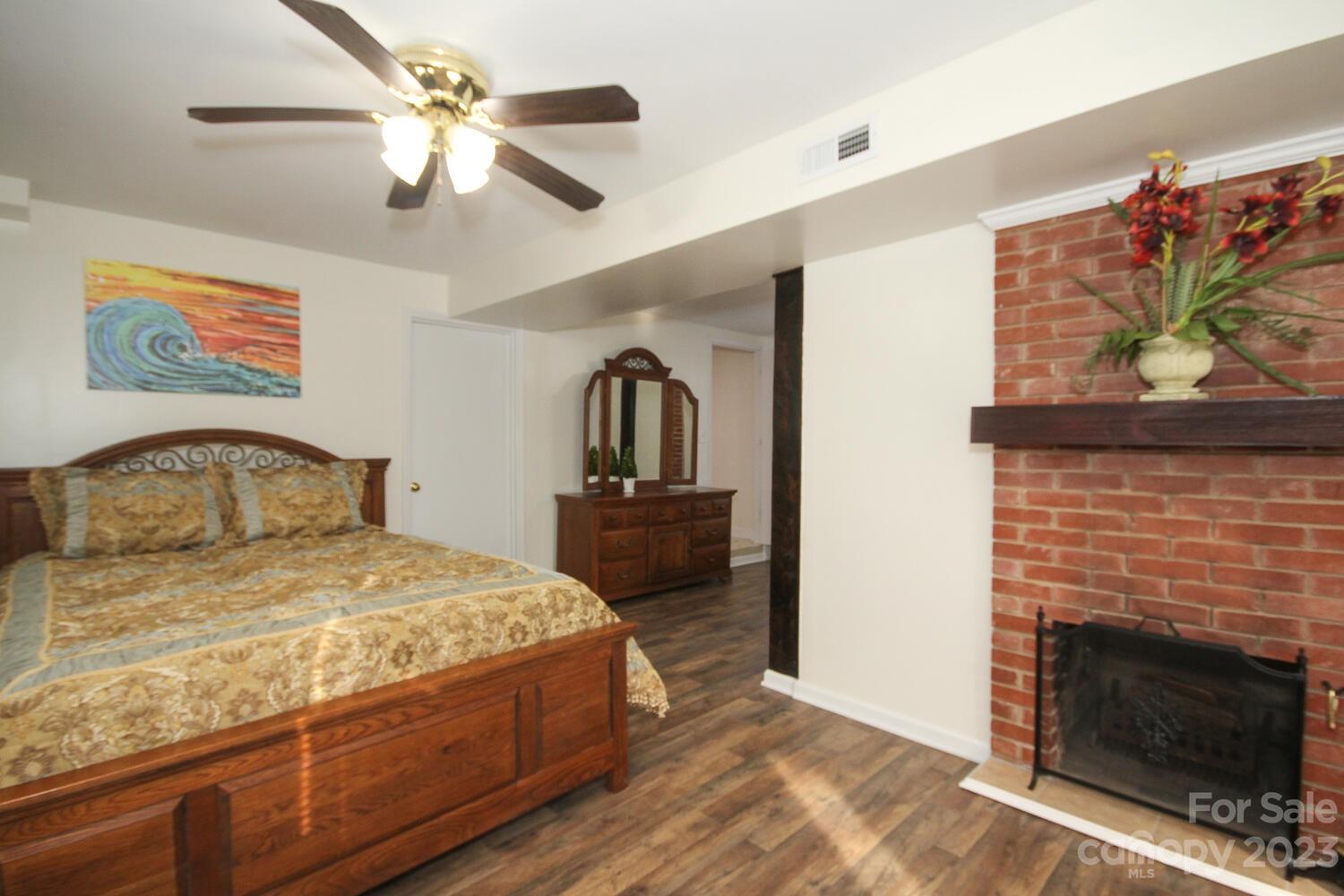 5615 Cypress Road Clover, SC 29710 - Photo 18 of 26 a bedroom with a bed a fireplace and a flat screen tv