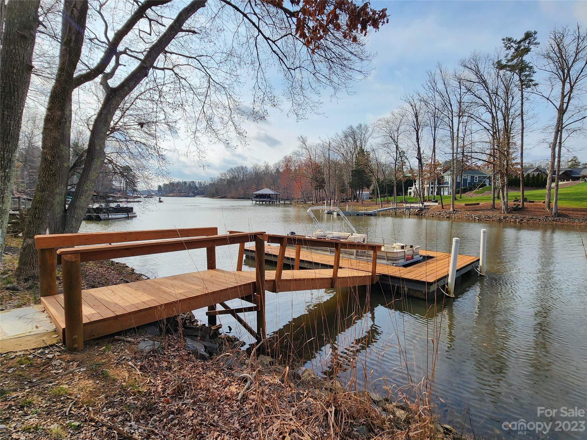 5615 Cypress Road Clover, SC 29710 - Photo 2 of 26 a lake view with a bench and trees around