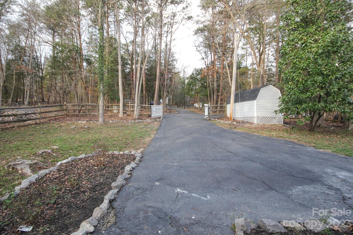 5615 Cypress Road Clover, SC 29710 - Photo 23 of 26 a view of a backyard with large trees and plants