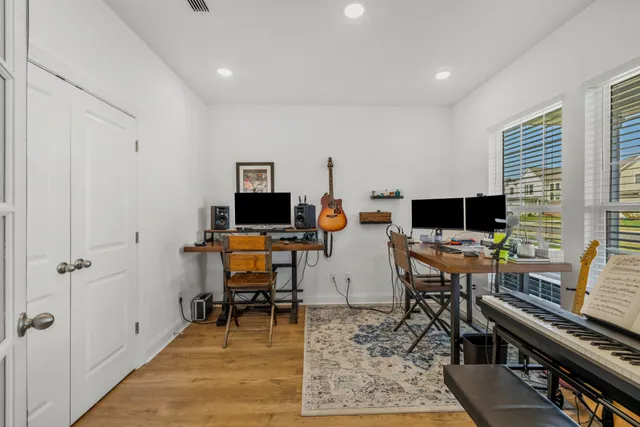 a view of a workspace with furniture and a window